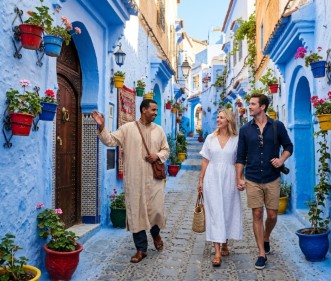 Tourists walking down the iconic blue streets of Chefchaouen Medina with a private guide