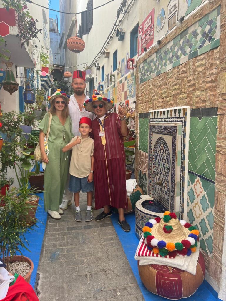 Family and guide in a colorful alley during the Tangier and Tetouan tour